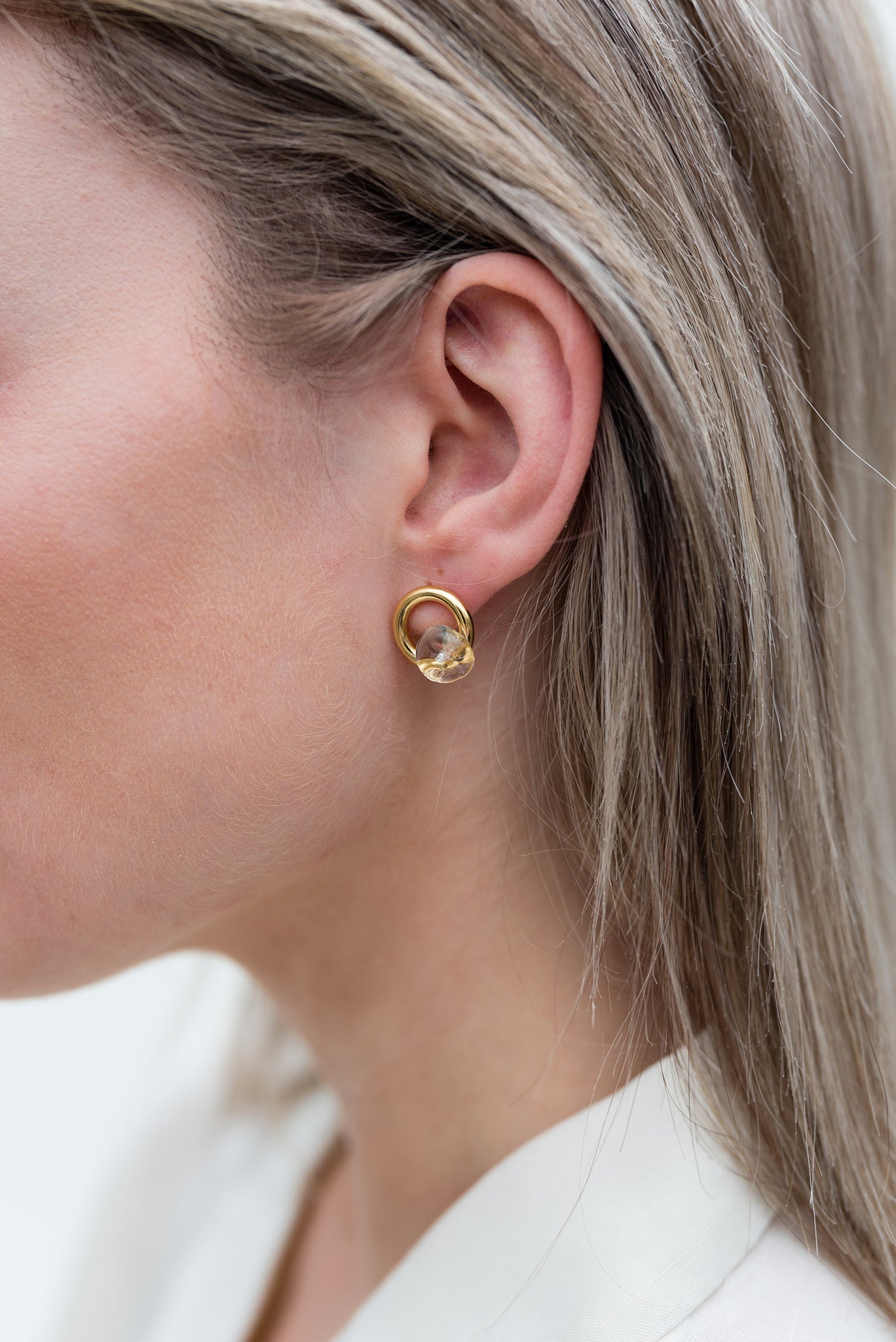 Model wearing ethical recycled silver gold plated earrings