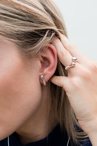 Model wearing ethical recycled silver ring and earrings
